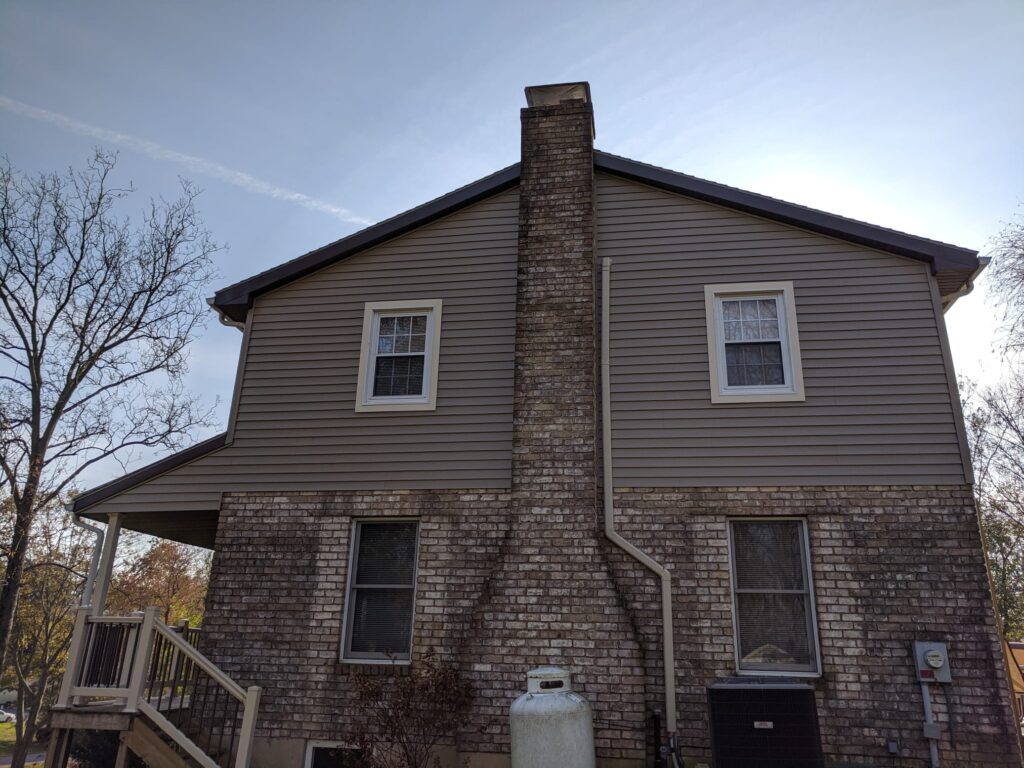 Side Exterior With Brick And Chimney