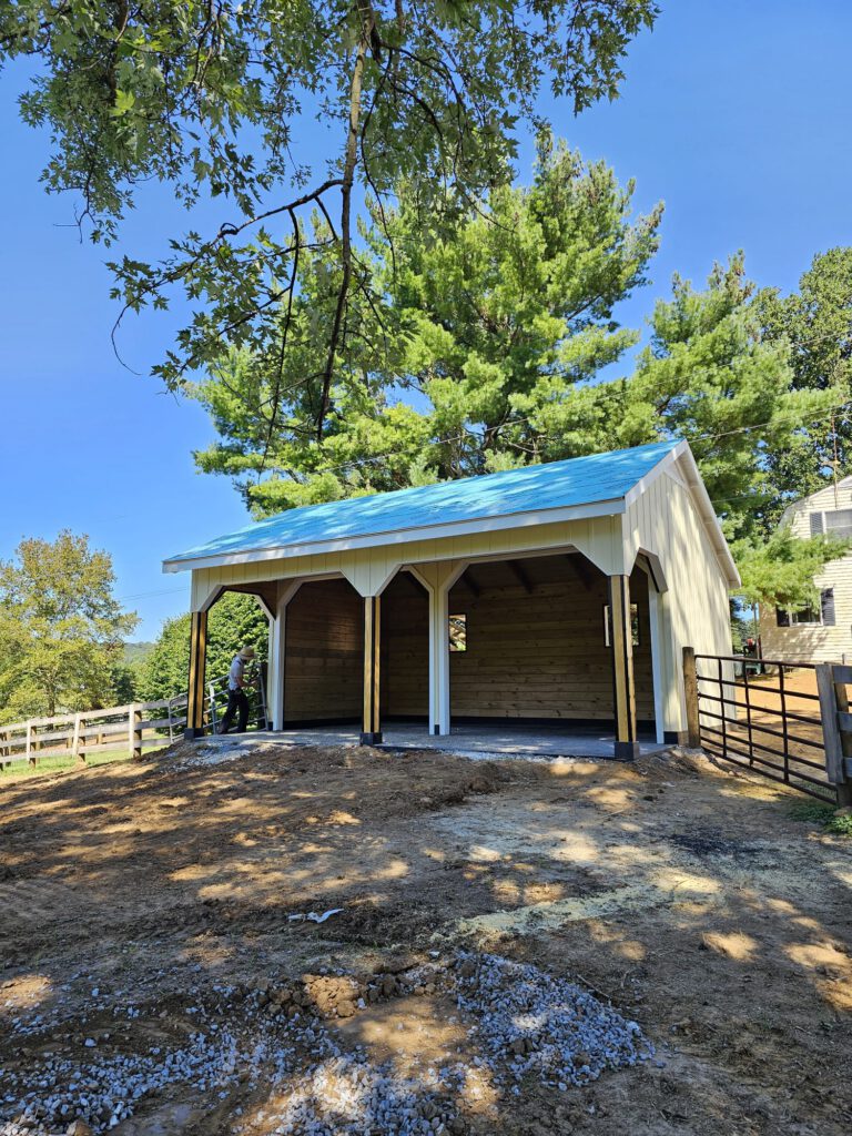 Horse Barn Construction In Ephrata, Pa Featuring Covered Horse Stalls, Natural Wood Interiors, And Custom Post-Frame Construction.